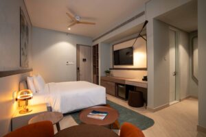 Sesaya Poshtel private room with ceiling fan and en-suite bathroom entrance
