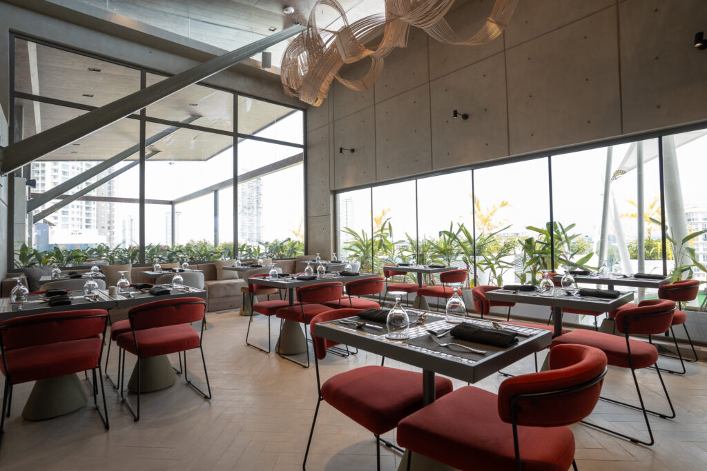 Canapé rooftop dining area with skyline views through floor-to-ceiling glass