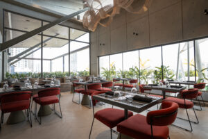Canapé rooftop dining area with skyline views through floor-to-ceiling glass