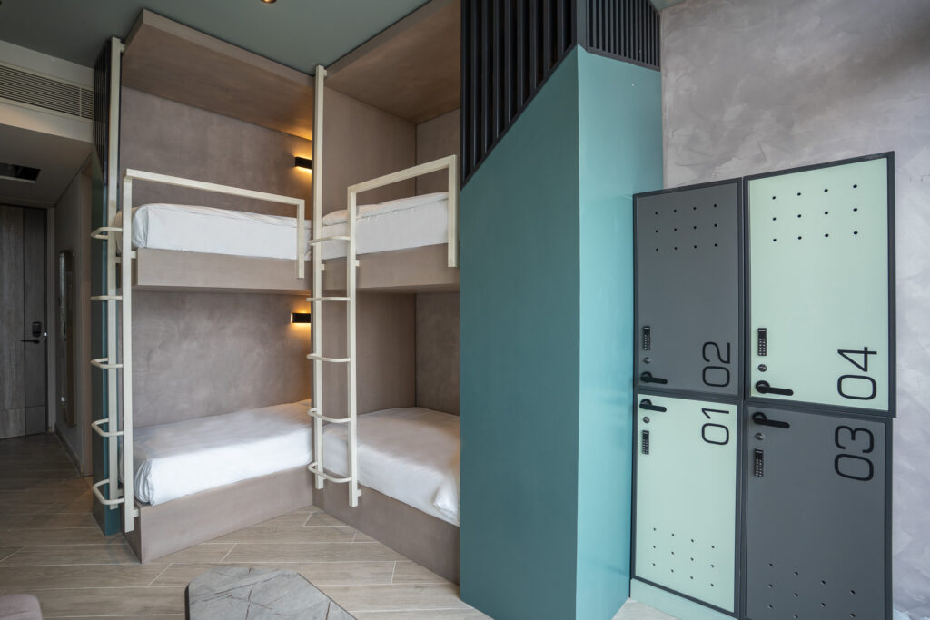 Sesaya Poshtel dormitory with teal lockers and bunk beds