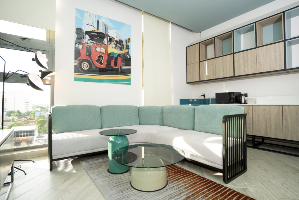 Sesaya Poshtel lounge with teal sofa and city-view window